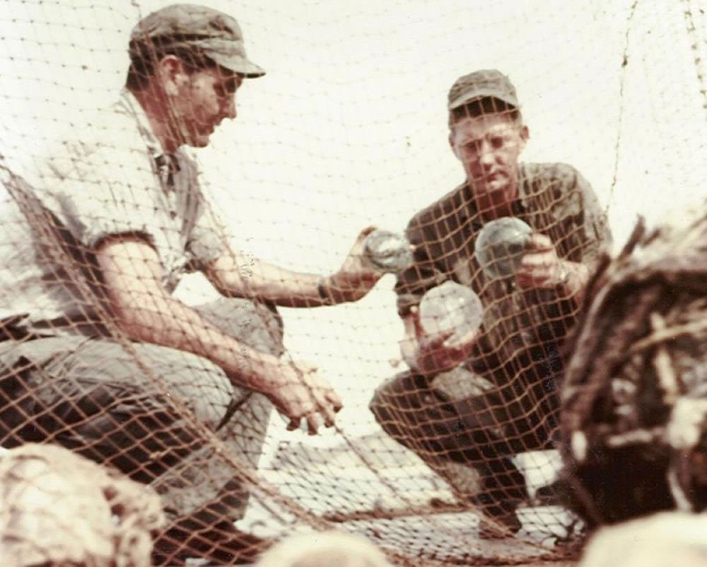 U.S. Navy Underwater Demolition Team members inspect glass ball floats used on North Korean fishing nets. The nets were captured during Operation Fishnet, whose mission was the destruction of the main source of Communist forces' food supply, the nets of North Korean fishermen. U.S. Navy UDT Frogmen took part in this operation. Photograph is dated 16 September 1952. Official U.S. Navy Photograph, now in the collections of the National Archives.