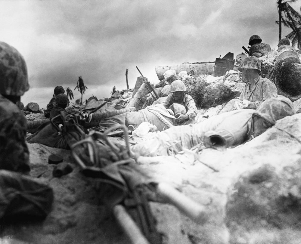 U.S. Marines seeking cover ashore during the Battle of Tarawa.