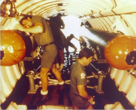 Men from UDT-12 are seen hard-mount installing the SWA inside the DDS